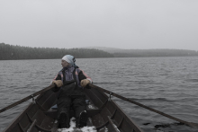 person rowing during snow fall